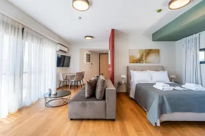 a bedroom with a bed and a couch at AURA Gazi apartments in Athens