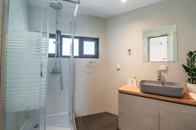 a bathroom with a shower and a sink at AURA Gazi apartments in Athens