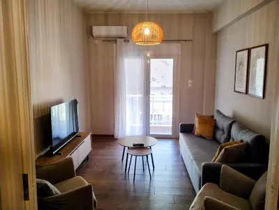 a living room with a couch and a tv at Dita's Cozy Stay in Athens