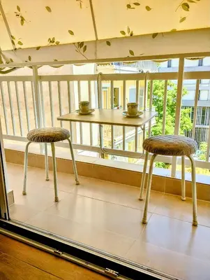 two chairs sitting on a balcony with a table at Dita's Cozy Stay in Athens