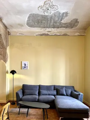 a living room with a blue couch and a ceiling at Sis Urban,Timeless Elegance in Athens