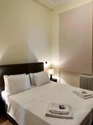 a bedroom with a bed with two towels on it at Sis Urban,Timeless Elegance in Athens
