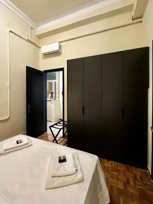a room with a bed with a black cabinet at Sis Urban,Timeless Elegance in Athens