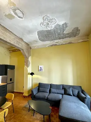 a living room with a couch and a ceiling at Sis Urban,Timeless Elegance in Athens