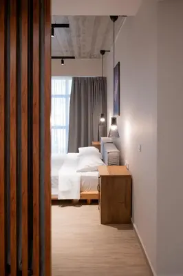 a bedroom with a white bed and a window at Never Space Up Apartment in Piraeus