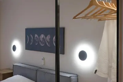 a bedroom with a bed and a picture on the wall at Never Space Up Apartment in Piraeus