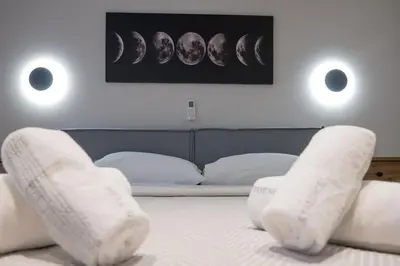a bedroom with a bed with white stockings on it at Never Space Up Apartment in Piraeus