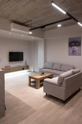 a living room with a couch and a table at Never Space Up Apartment in Piraeus