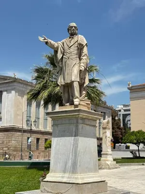 a statue of a man standing in front of a building at Platon Loft in Athens