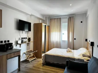 a bedroom with a bed and a tv on the wall at Platon Loft in Athens