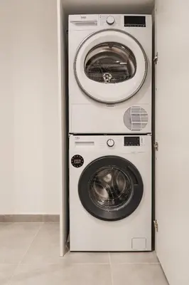 a washing machine and a dryer in a closet at Ella Luxury Suites in Athens
