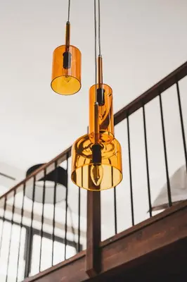 three lights hanging from a balcony with a railing at Ella Luxury Suites in Athens