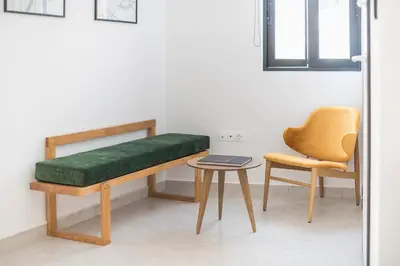 a room with a bench and a chair and a table at Huge Balcony Penthouse in City Center - Zen Asteria in Athens