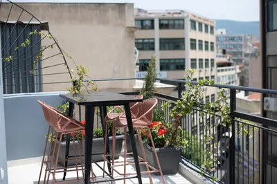 a balcony with a table and chairs on a balcony at Huge Balcony Penthouse in City Center - Zen Asteria in Athens