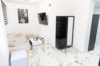 a living room with a marble floor and a mirror at Apartment with jacuzzi and sauna in Athens