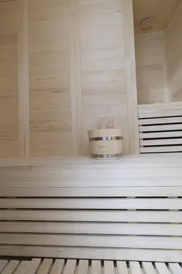 a sauna with a bucket on a shelf at Apartment with jacuzzi and sauna in Athens