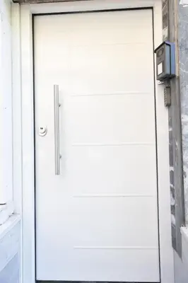 a white garage door with a sign on it at Apartment with jacuzzi and sauna in Athens