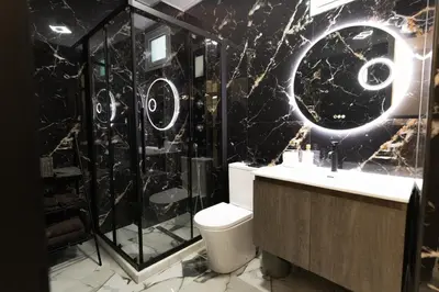 a bathroom with a toilet and a shower and a sink at Apartment with jacuzzi and sauna in Athens