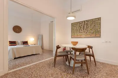 a room with a table and chairs and a bed at Kismet Urban Stay in Athens