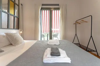 a bedroom with a bed with two towels on it at Kismet Urban Stay in Athens