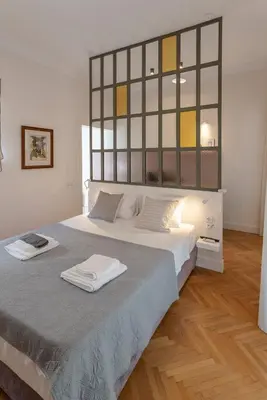 a bedroom with a large bed with two towels on it at Kismet Urban Stay in Athens