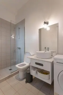 a bathroom with a toilet and a sink and a shower at Kismet Urban Stay in Athens