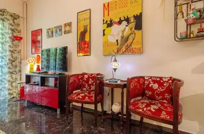 a living room with two chairs and a table at Casa Di Fiori Pireas in Piraeus