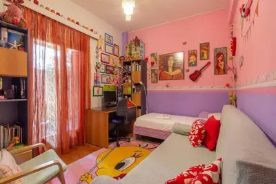 a room with a bed and a desk with a computer at Casa Di Fiori Pireas in Piraeus