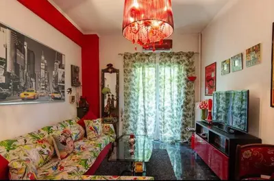 a living room with a couch and a large window at Casa Di Fiori Pireas in Piraeus