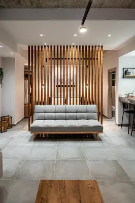 a living room with a couch and a table at Wooden Style Apartment in Piraeus in Piraeus