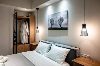 a bedroom with a bed and a painting on the wall at Wooden Style Apartment in Piraeus in Piraeus