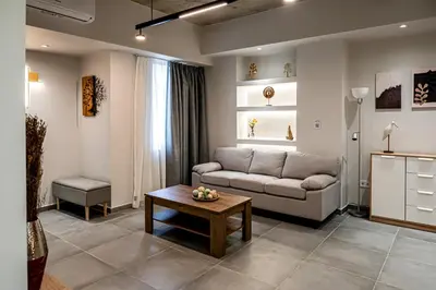 a living room with a couch and a table at Wooden Style Apartment in Piraeus in Piraeus