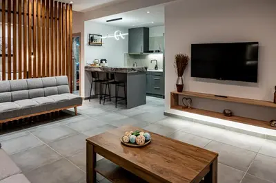 a living room with a couch and a table at Wooden Style Apartment in Piraeus in Piraeus
