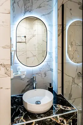 a bathroom with a sink and a mirror at Wooden Style Apartment in Piraeus in Piraeus