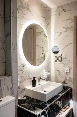 a bathroom with a white sink and a mirror at Vintage Road Apartment in Piraeus in Piraeus