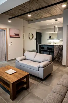 a living room with a couch and a table at Vintage Road Apartment in Piraeus in Piraeus