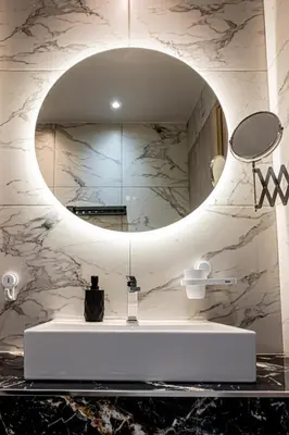 a bathroom with a sink and a mirror at Vintage Road Apartment in Piraeus in Piraeus