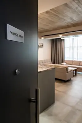 a door in a room with a living room at Vintage Road Apartment in Piraeus in Piraeus