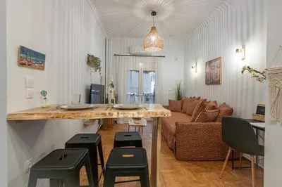 a living room with a table and a couch at Cozy Apartment in Exarchia, Walk to Athens Museum in Athens