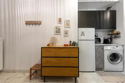 a kitchen with a refrigerator and a washer and dryer at Cozy Apartment in Exarchia, Walk to Athens Museum in Athens