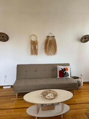a living room with a couch and a table at Plaka's Central, Cozy and Comfort Home in Athens