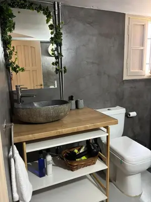 a bathroom with a sink and a toilet at Plaka's Central, Cozy and Comfort Home in Athens