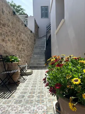 a stairway with flowers in pots on a tile floor at Plaka's Central, Cozy and Comfort Home in Athens