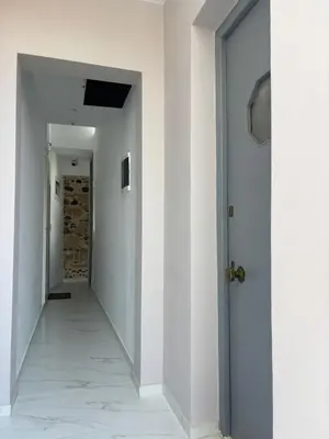 an empty hallway with white walls and a door at Plaka's Central, Cozy and Comfort Home in Athens