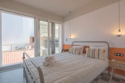 a bedroom with a bed with two stuffed animals on it at Charming apartment on Athens most famous street in Athens