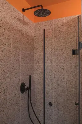 a shower in a bathroom with an orange ceiling at Charming apartment on Athens most famous street in Athens