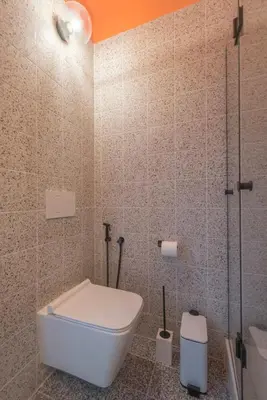 a bathroom with a toilet and a glass shower at Charming apartment on Athens most famous street in Athens