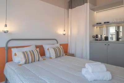 a bedroom with a bed with two towels on it at Charming apartment on Athens most famous street in Athens