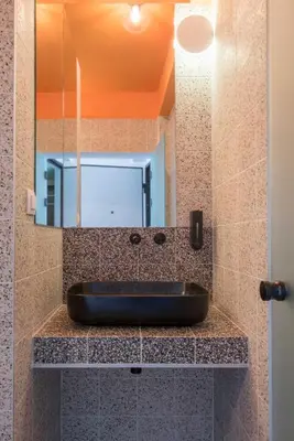 a bathroom with a sink and a mirror at Charming apartment on Athens most famous street in Athens