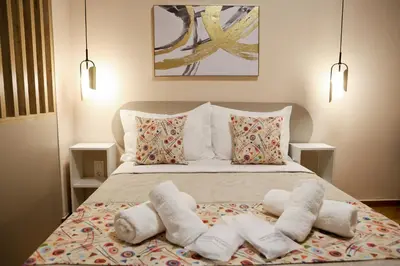 a bedroom with a bed with towels on it at Best House Cleo Pasalimani Piraeus in Piraeus